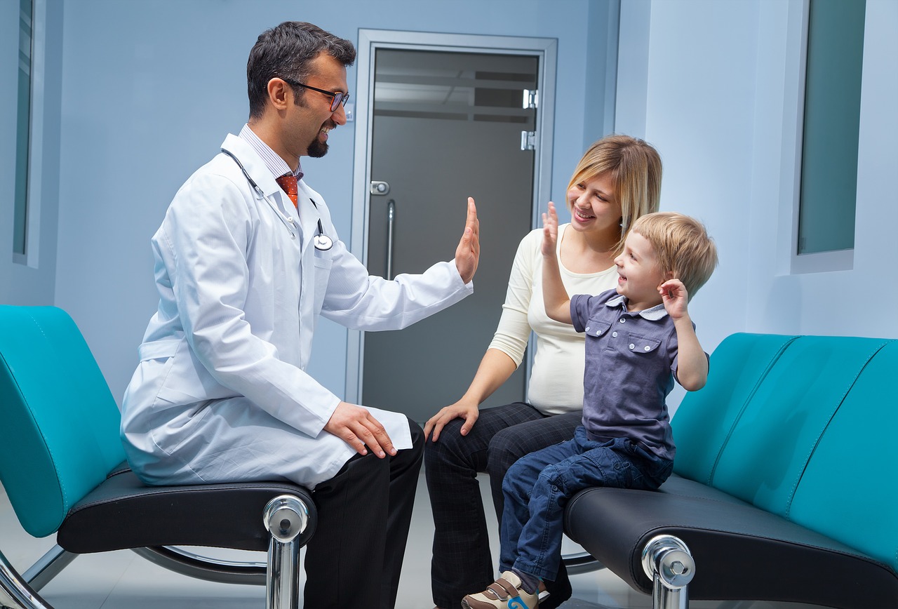 A chiropractor and a child share a moment on a bench outside a chiropractic clinic, promoting health and wellness.