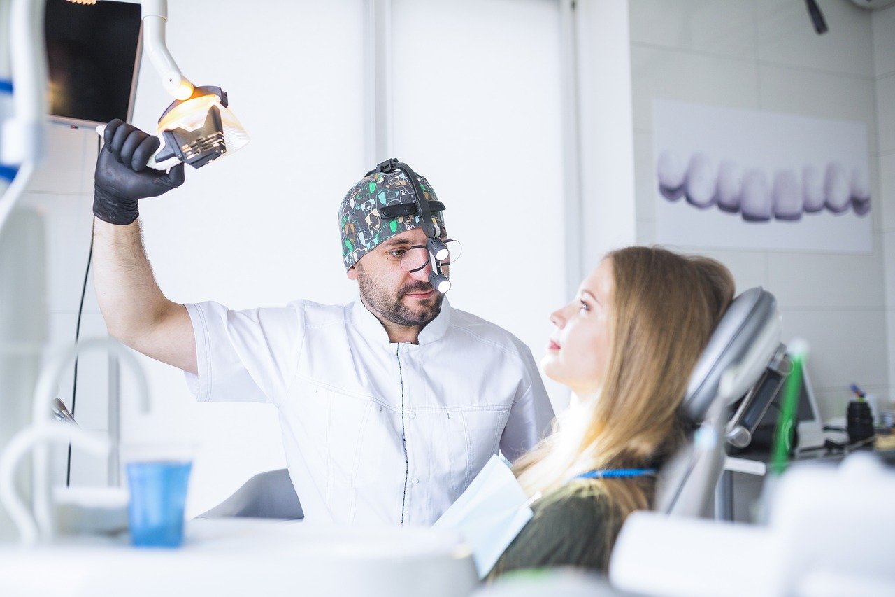 A man and woman engage in a consultation at a dental office, highlighting the professional atmosphere of the practice.