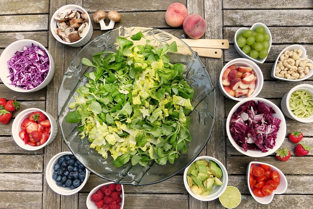 A colorful salad bowl filled with a variety of fresh fruits and vegetables, perfect for a nutritious meal in a food service setting