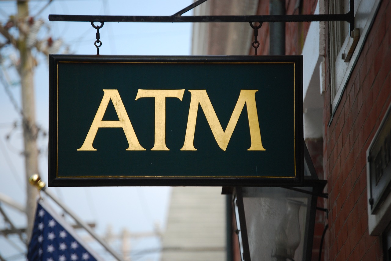 A sign displaying the word "ATM," indicating the presence of an automated teller machine for financial transactions.