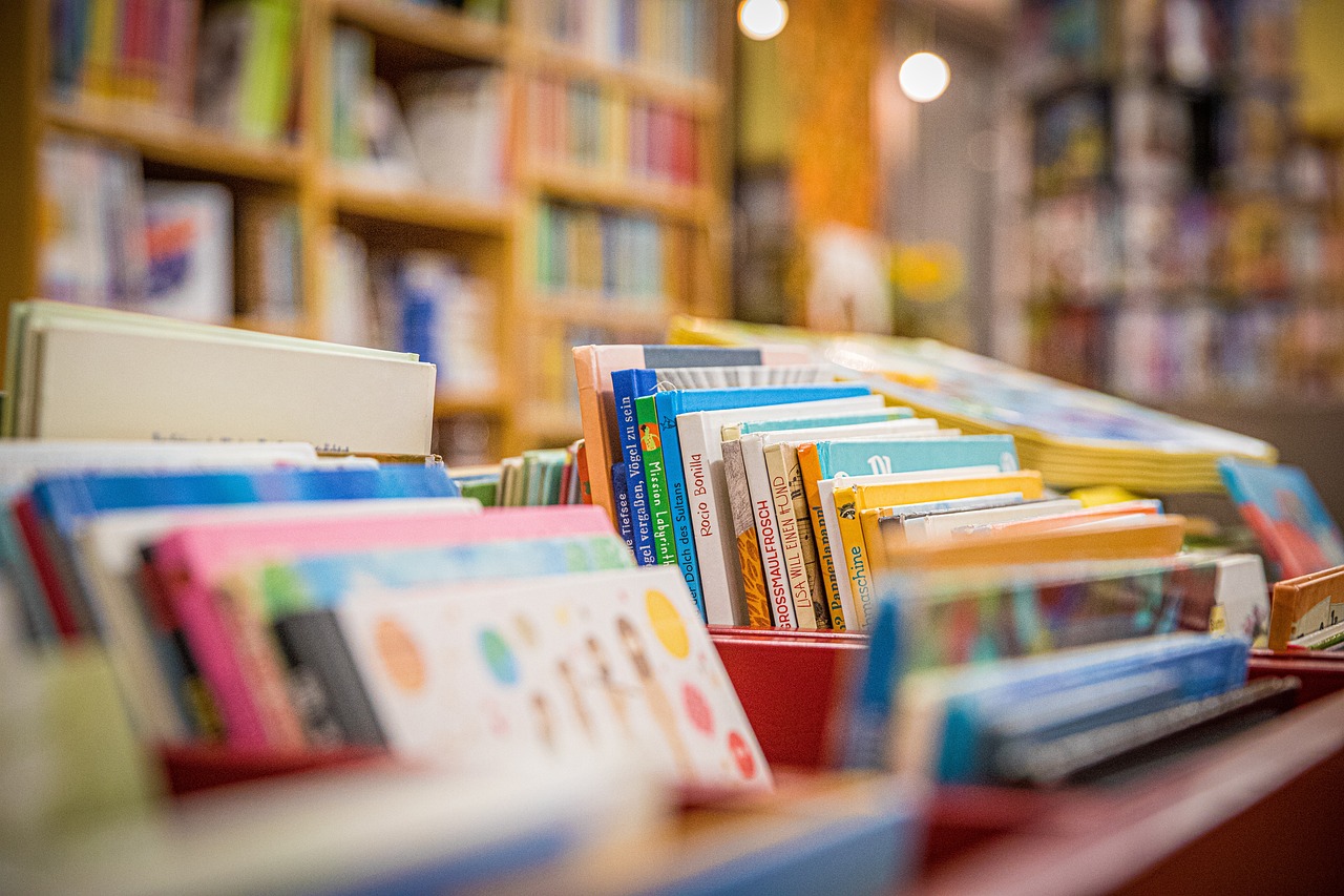 A red box filled with various books, symbolizing resources for self-enrichment and education services.