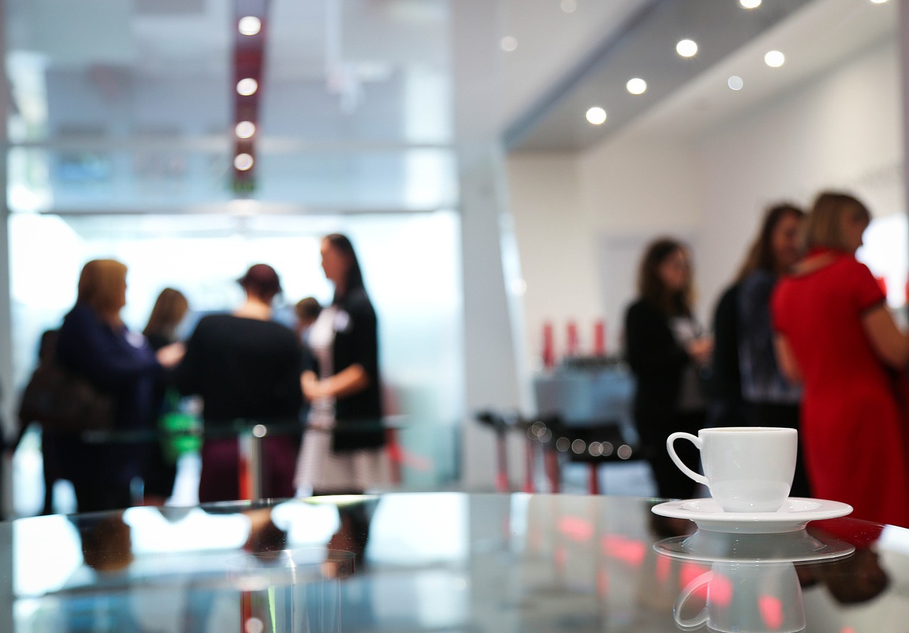 A coffee cup sits on a table in a conference room, representing a professional environment for interviewing and survey services.