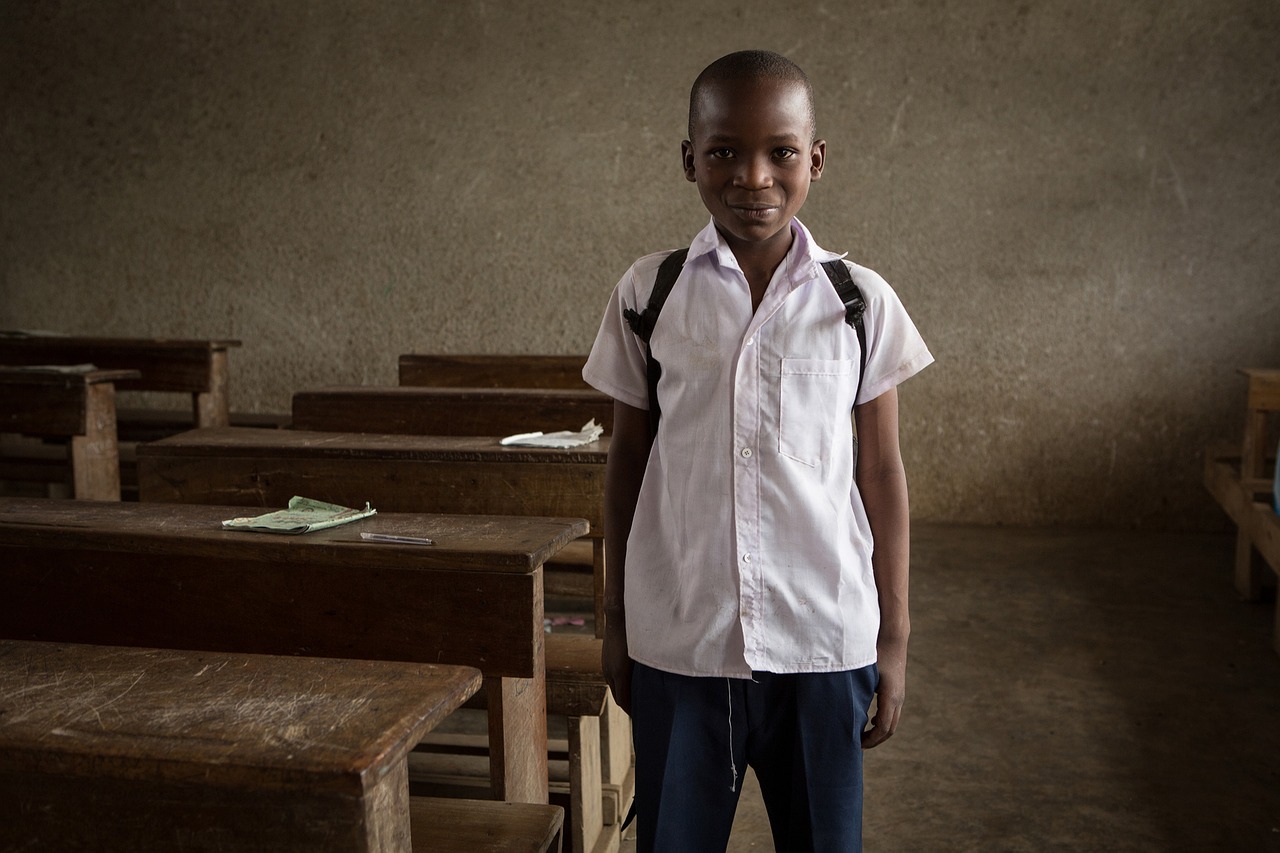 A young boy stands confidently in front of a classroom, embodying the spirit of learning and inclusion in special education.