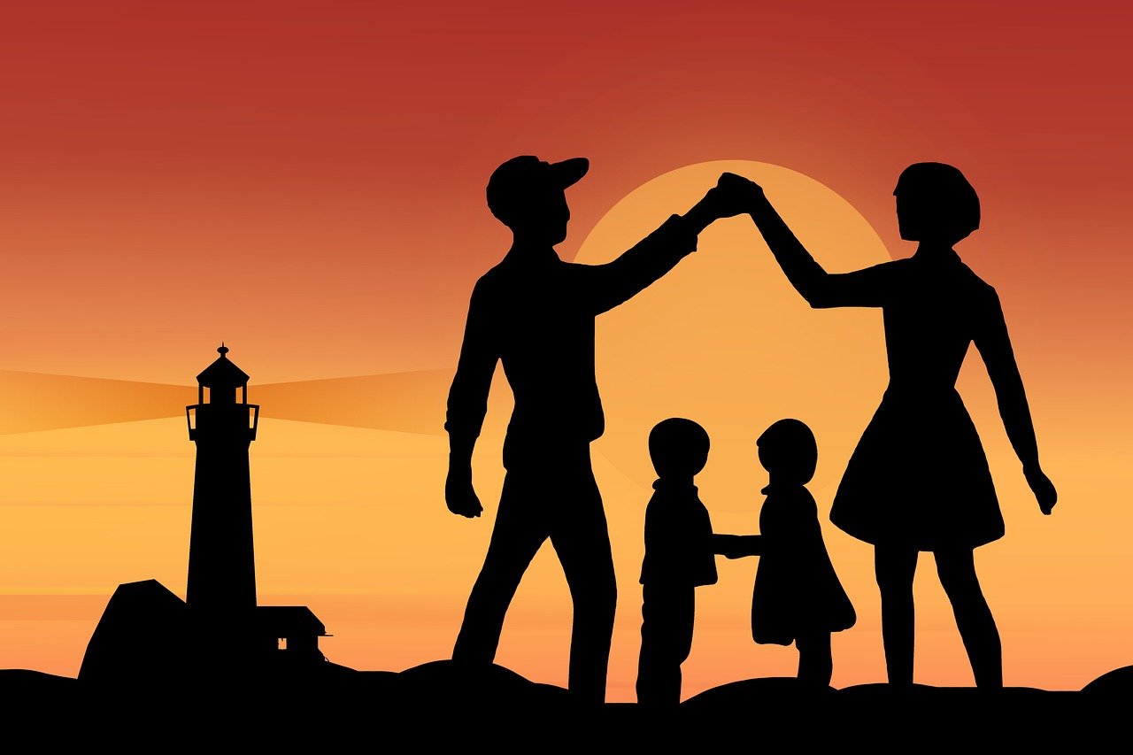 Family silhouette at sunset, hands joined, embodying love and safety, resonating with the mission of an insurance sales agency.