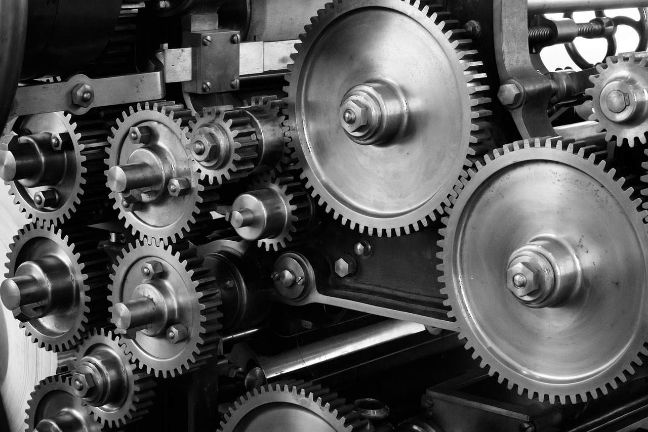 A monochrome photograph showcasing a machine's gears, representing the essence of industrial machinery maintenance.