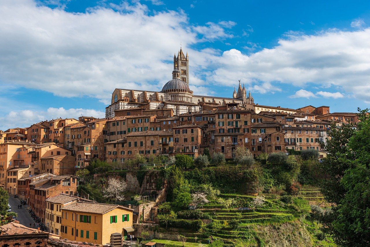 A panoramic view of Siena, Italy, showcasing its historic architecture and vibrant urban landscape.