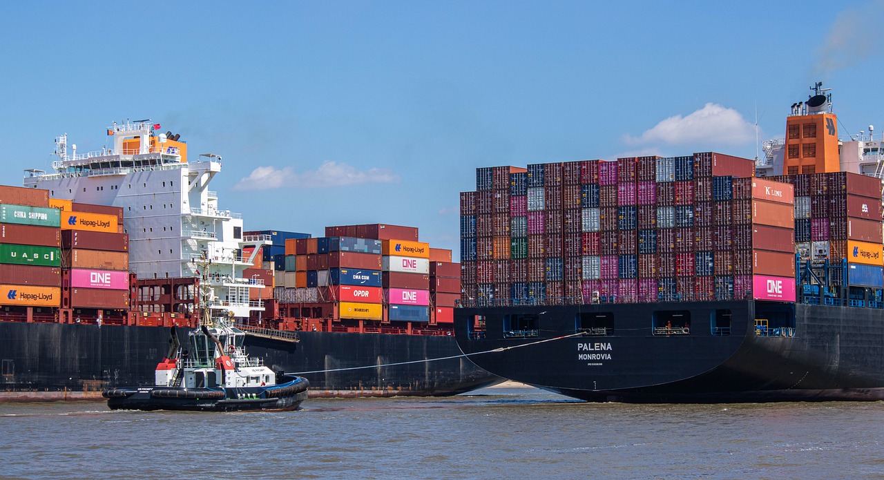 A large cargo ship loaded with numerous containers, symbolizing global trade and logistics in the procurement service industry.