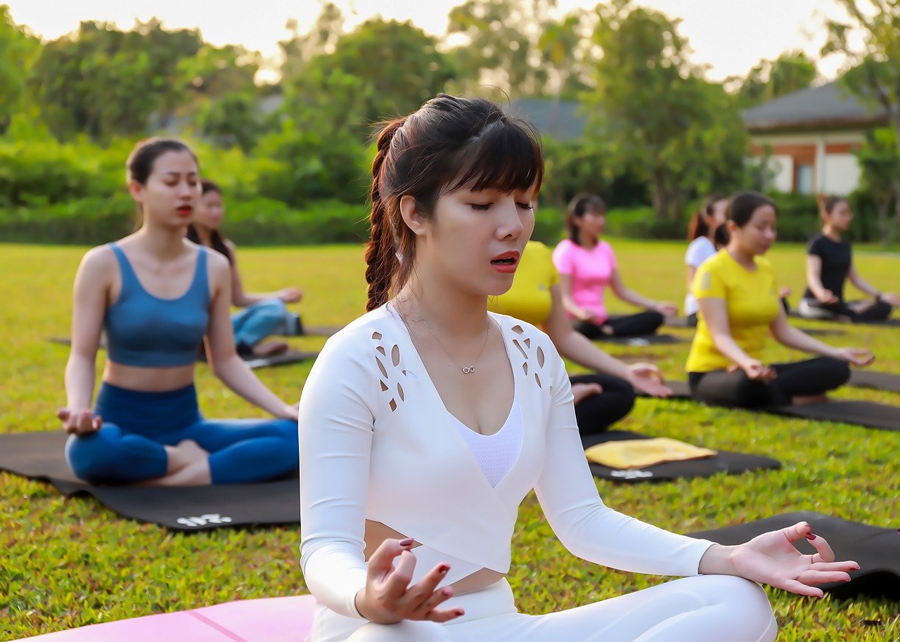 Participants practicing yoga in a tranquil Hanoi setting, highlighting the recreation center's welcoming atmosphere.